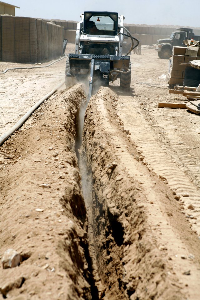 US Navy 080728-N-9623R-006 quipment Operator 3rd Class Zachariah Almaraz uses a trencher to dig a path