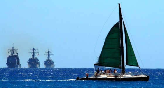 US Navy 080729-N-0879R-001 A sailboat crosses in front of the group of U.S. Navy ship's led by the cruiser USS Lake Erie (CG 70)