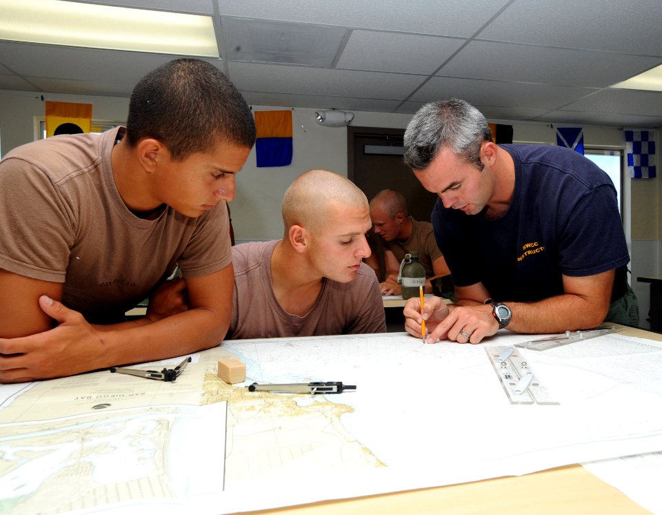 US Navy 080729-N-6552M-035 Special Boat Operator 1st Class Zach Riley teaches students how to lay out navigational tracks on a chart