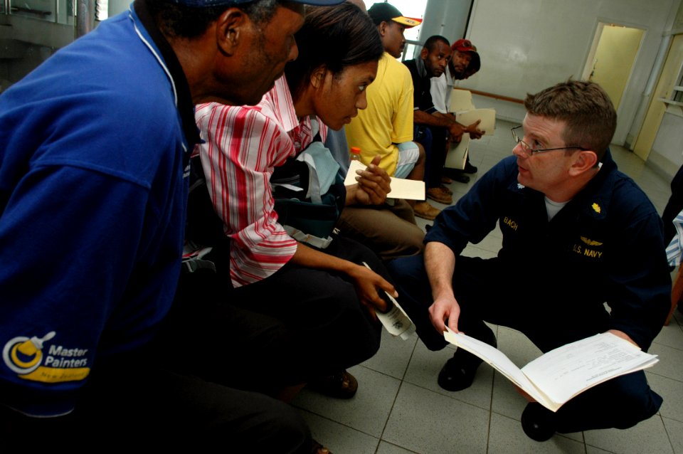 US Navy 080805-N-1328S-007 Cmdr. Kevin Bach consults a patient at Port Moresby General Hospital