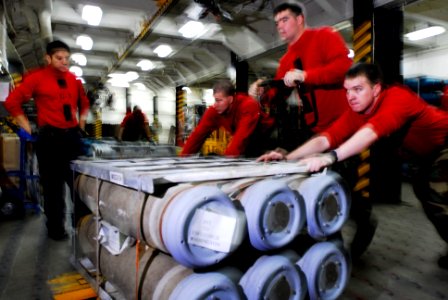 US Navy 080802-N-7883G-020 Weapons department personnel move bombs onto an elevator aboard the aircraft carrier USS Kitty Hawk (CV 63)