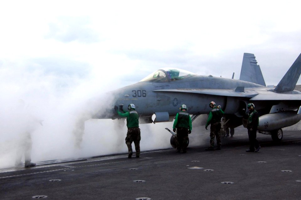 US Navy 080806-N-9170G-012 Sailors align an F-A-18C Hornet assigned to Strike Fighter Squadron (VFA) 192 onto a catapult aboard the aircraft carrier USS Kitty Hawk (CV 63) for its final launch from the retiring warship