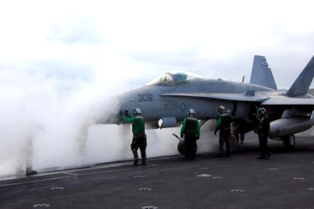 US Navy 080806-N-9170G-012 Sailors align an F-A-18C Hornet assigned to Strike Fighter Squadron (VFA) 192 onto a catapult aboard the aircraft carrier USS Kitty Hawk (CV 63) for its final launch from the retiring warship
