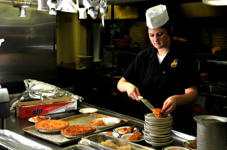 US Navy 080731-N-7981E-116 Operations Specialist Seaman Apprentice Amy Caccamise prepares pie servings