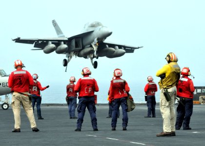 US Navy 080730-N-7981E-246 Flight deck personnel wait in the de-arming area as an F-A-18F Super Hornet is recovered aboard the Nimitz-class aircraft carrier USS Abraham Lincoln (CVN 72)