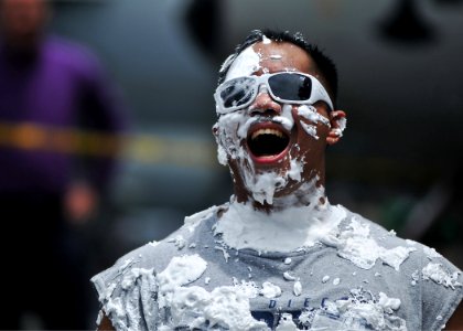 US Navy 080726-N-7981E-418 Hospital Corpsman 1st Class Ferdinand Ajel laughs after taking a pie in the face photo
