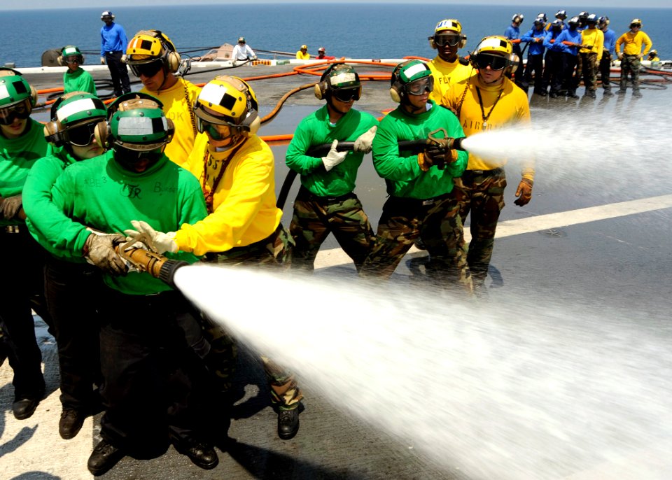 US Navy 080804-N-7571S-004 Flight Deck personnel conduct firefighting and hose-handling techniques
