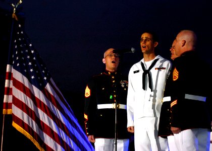 US Navy 080808-N-0841E-315 Sailors and Marines perform the national anthem to a capacity crowd of more than 15,000 fans at Little Creek Amphibious Base before a performance by country music singer Gretchen Wilson