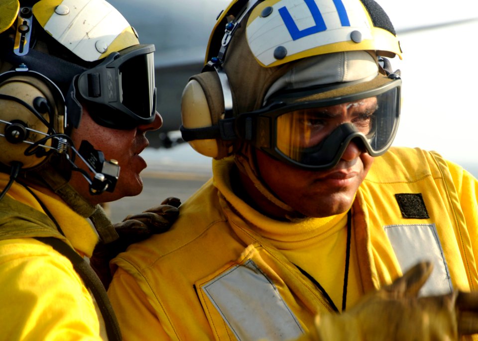 US Navy 080728-N-7571S-003 Aviation Boatswain's Mates (Handling) communicate on the flight deck of the aircraft carrier Theodore Roosevelt (CVN 71)