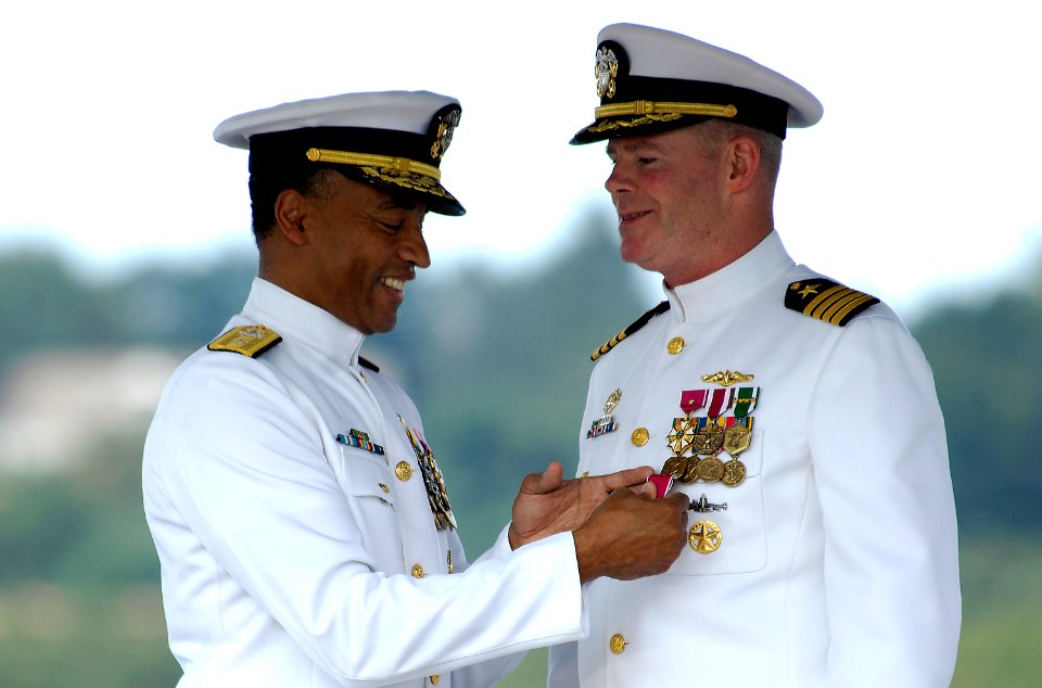 US Navy 080801-N-8467N-001 Rear Adm. Bruce E. Grooms, left, presents Capt. David M. Hendricks with the Meritorious Service Medal at the Regional Support Group Groton change of command