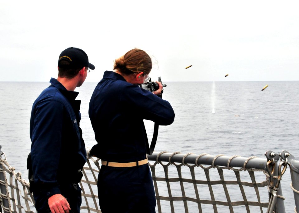 US Navy 080729-N-1488S-009 unner's Mate 2nd Class Richard Slade teaches Midshipman 3rd Class Elizabeth Subjeck how to fire an M-16 rifle