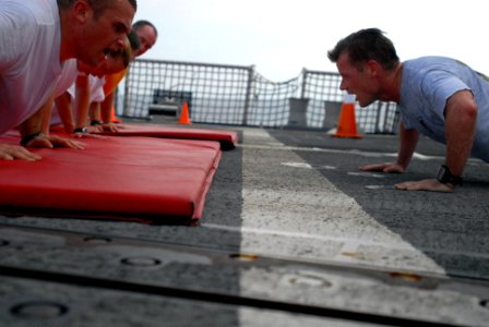 US Navy 080805-N-4995K-450 Command Master Chief Christopher Angstead performs push-ups with new chief petty officer selectees photo