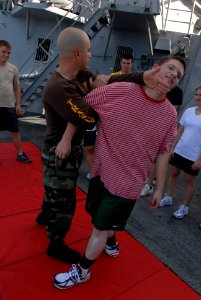 US Navy 080804-N-4995K-123 Sonar Technician (Surface) 1st Class Eric Hall demonstrates how to properly perform a take down photo