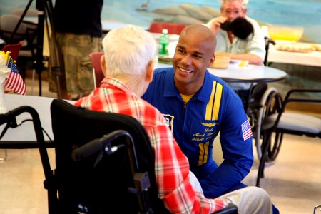 US Navy 080808-N-3271W-037 Lt. Cmdr. Mark Lambert, flight surgeon for the Navy flight demonstration squadron Blue Angels, visits with a resident of the nursing home care center at Spokane Veterans Administration Hospital