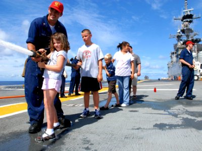 US Navy 080808-N-9905J-107 Damage Controlman 2nd Class Jonathon Baxter directs a firefighting demonstration during Gator Cruise 2008 aboard the amphibious assault ship USS Essex (LHD 2)