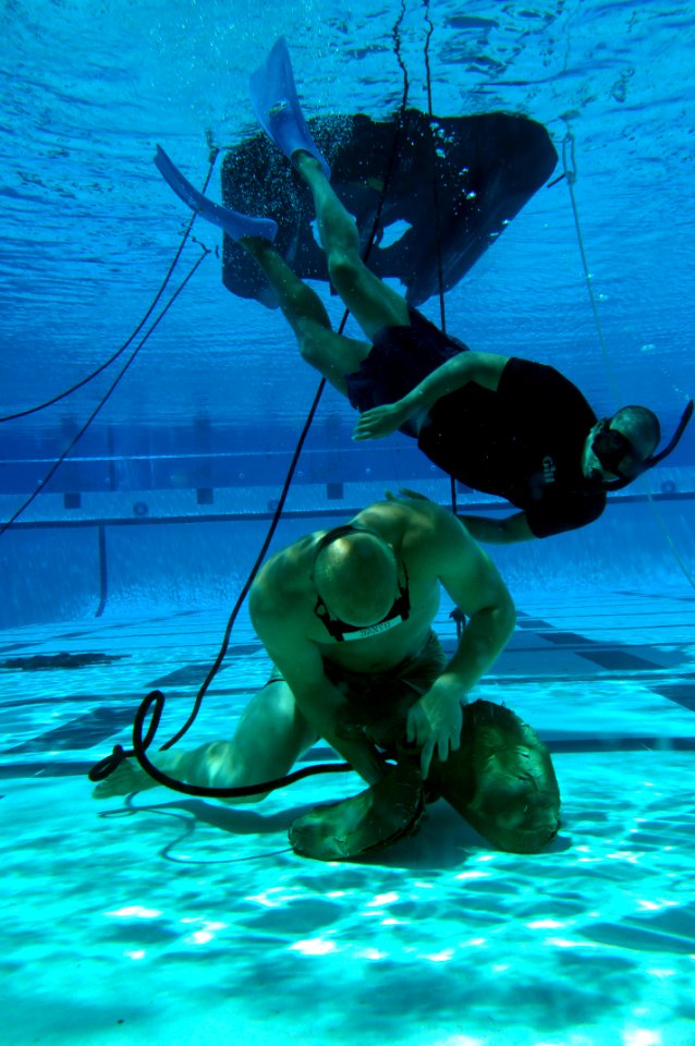 US Navy 080805-N-6552M-048 A Basic Crewman Training (BCT) student demonstrates underwater knot tying skills during water proficiency training at Naval Amphibious Base Coronado photo