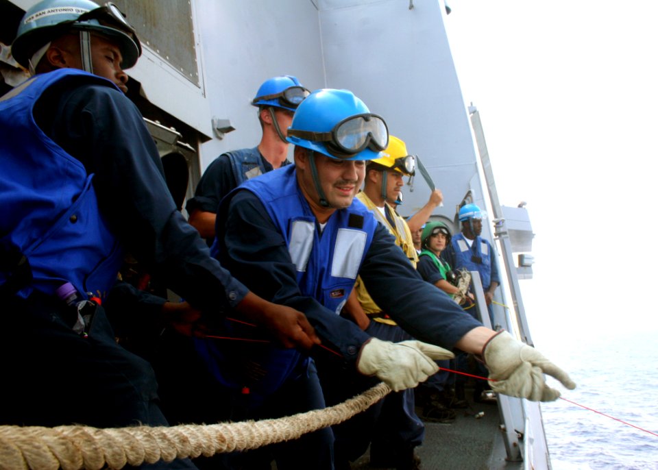 US Navy 080729-N-6764G-114 Boatswain's Mate 3rd Class Shaun Lewis and Boatswain's Mate 3rd Class Shawn Nelson pull line from the Military Sealift Command fleet replenishment oiler USNS Leroy Grumman