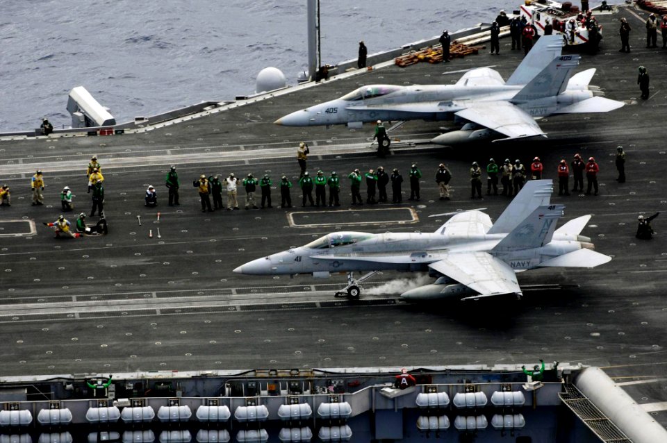 US Navy 080806-N-7883G-272 Two F-A-18C Hornets assigned to Strike Fighter Squadron (VFA) 195 launch from the aircraft carrier USS Kitty Hawk (CV 63) for the last time