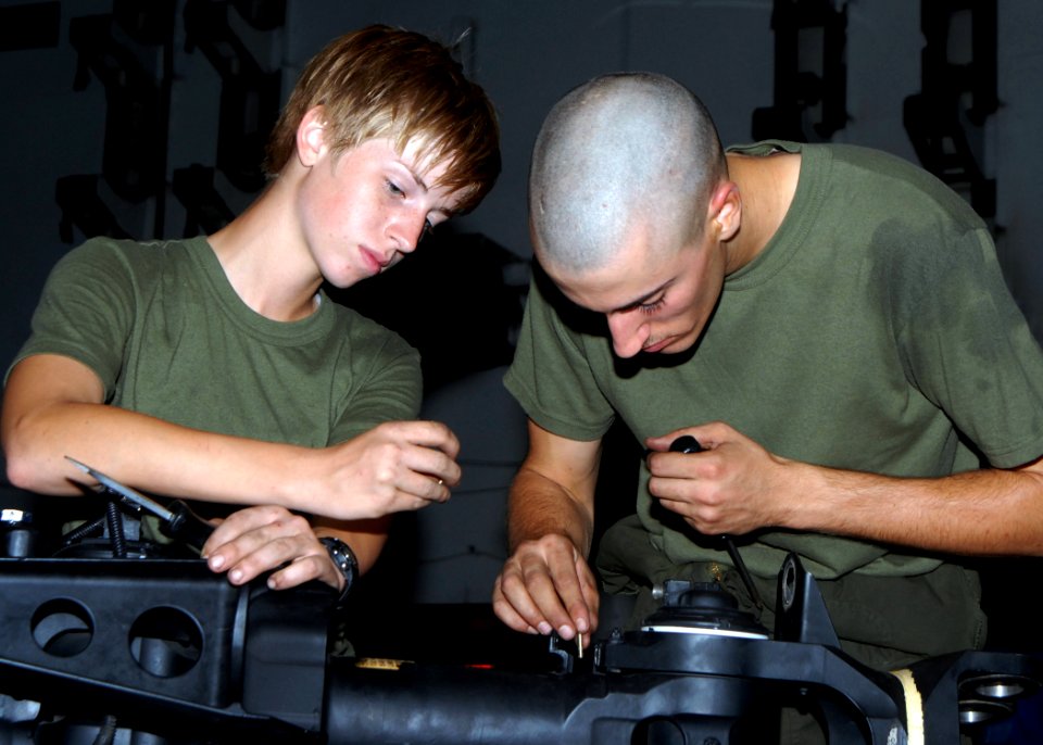 US Navy 080806-N-9604C-007 Marine Corps Lance Cpl. Afton Cagle, left, and Cpl. Bryan Paduano work together to remove the tie bar on a CH-46 rotor head