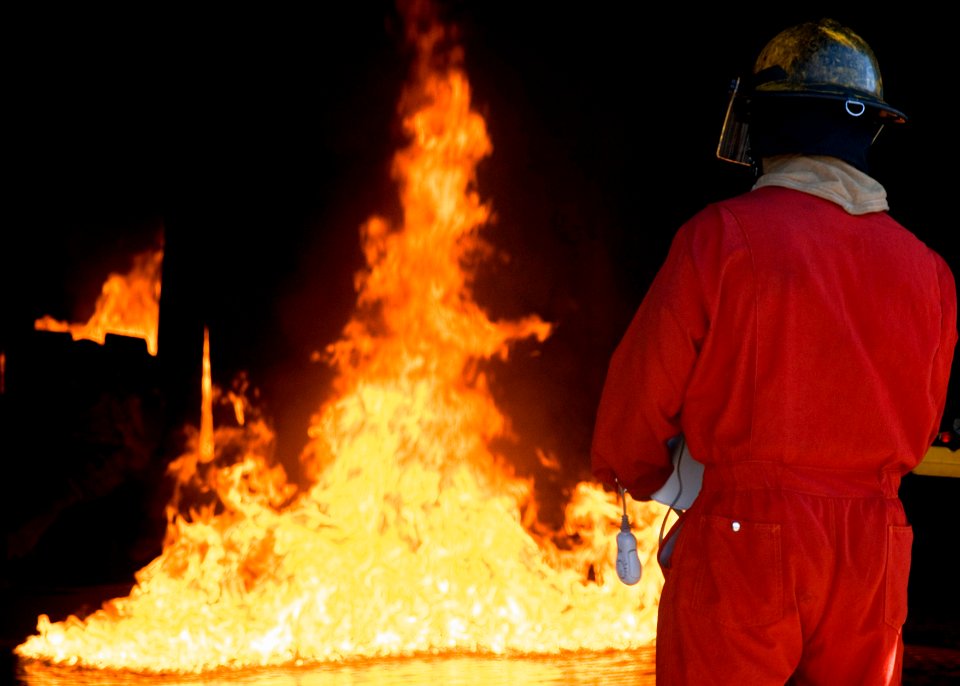 US Navy 080801-N-0995C-018 A Damage Controlman observes a mock helicopter fire at the Center for Naval Engineering Learning Site, Pearl Harbor