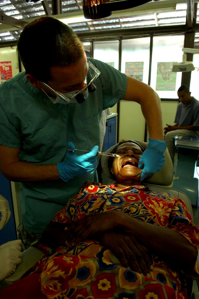 US Navy 080807-N-5086M-065 Army dentist Capt. Alex Smith, a U.S. Army dentist from New York, applies anesthesia to a patient during a dental civic action program