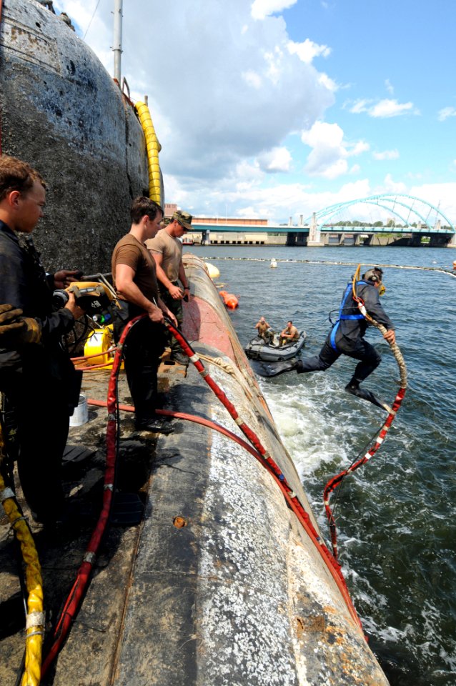 US Navy 080810-N-8933S-082 Navy Diver 1st Class Michael Linzy jumps off the former Soviet submarine-urned museum, Juliett 484. The submarine sank at her mooring point in about 30 feet of water after a nor'easter struck Providen