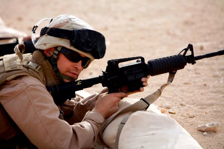 US Navy 080801-N-9623R-038 Equipment Operator 2nd Class Rodney Friesen, assigned to Naval Mobile Construction Battalion (NMCB) 17, waits for instructions from the range coach on the Battle Zero range photo