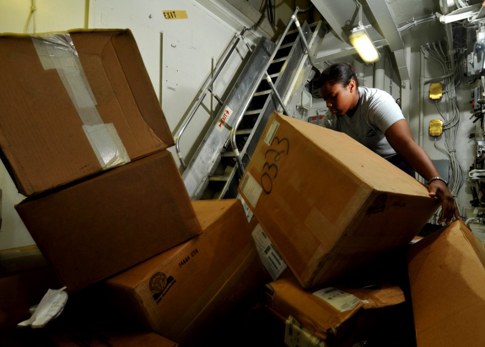 US Navy 080807-N-7981E-535 Storekeeper Seaman Kiera Burrell, from San Antonio, Texas, helps transfer supplies down several decks to the flight clothing storeroom aboard the aircraft carrier USS Abraham Lincoln (CVN 72)