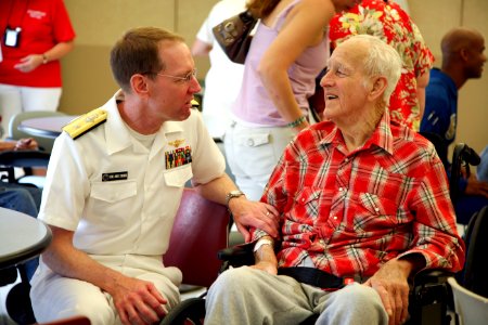 US Navy 080808-N-3271W-046 Rear Adm. James A. Symonds, commander, Navy Region Northwest, visits with a resident of the nursing home care center at Spokane Veterans Administration Hospital photo