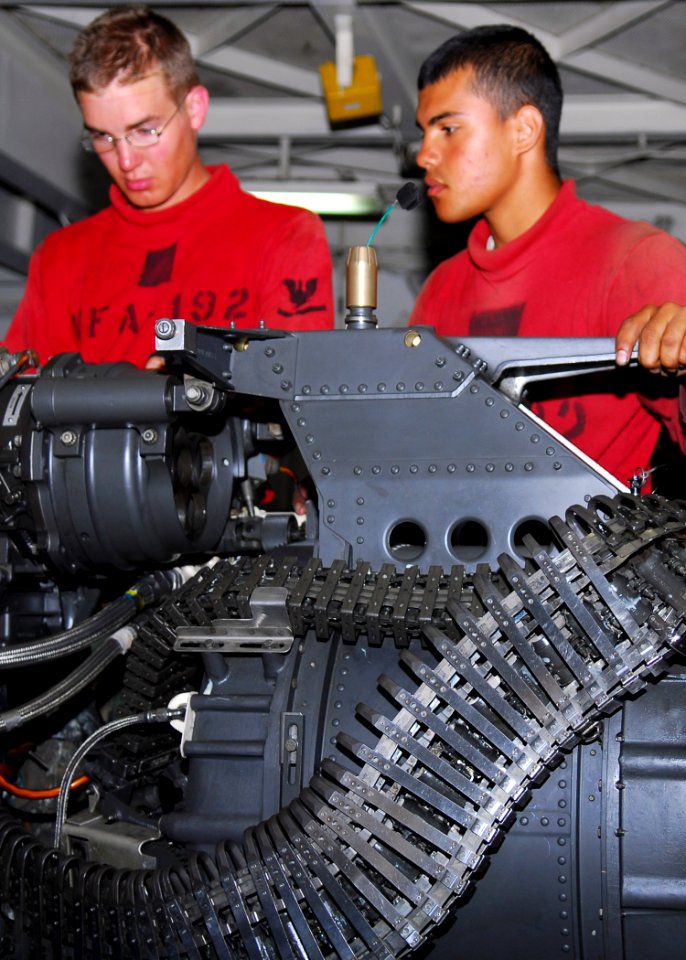 US Navy 080802-N-2638R-002 Aviation Ordnanceman 3rd Class Brandon Yarberry and Aviation Ordnanceman 2nd Class Michael Rodriguez conduct a routine inspection on a 20mm MK-61 automatic gun