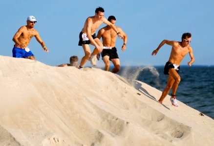 US Navy 080809-N-5345W-003 Runners make their way over the first sand dune on the beach at Naval Amphibious Base Little Creek (NABLC) at the start of the eighth annual Health Net Armed Services YMCA Mud Run