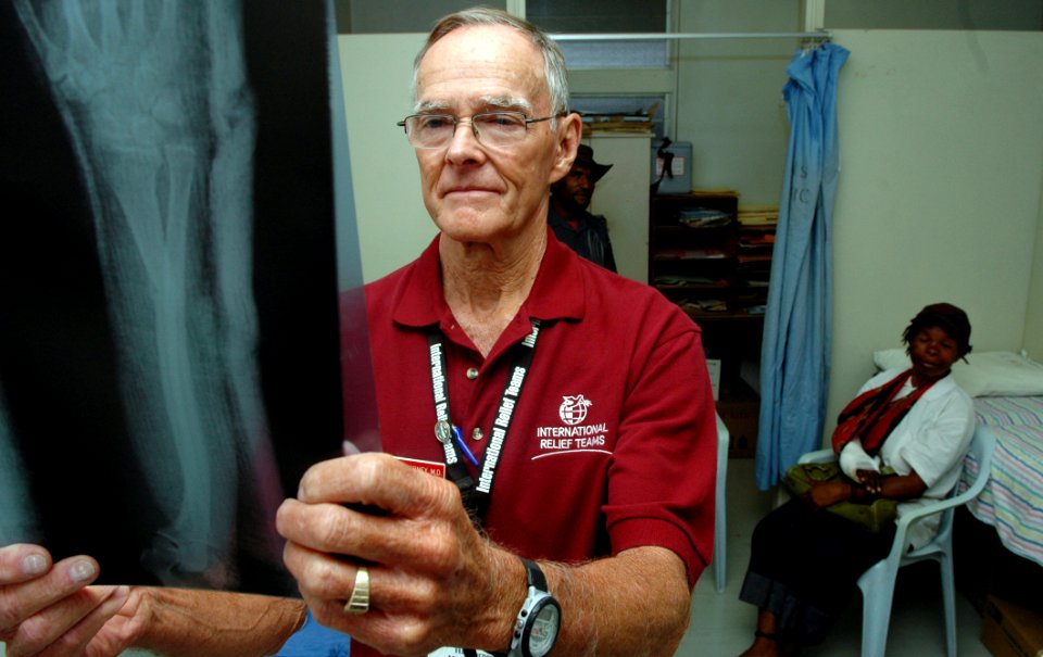 US Navy 080805-N-1328S-002 Dr. Harold Forney, a member of an international relief team working with Pacific Partnership, studies a patient's X-ray