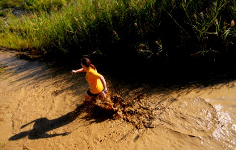 US Navy 080809-N-5345W-372 A runner sloshes her way through the final mud pit as she approaches the finish line of the eighth annual Health Net Armed Services YMCA Mud Run at Naval Amphibious Base Little Creek