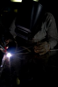 US Navy 080809-N-7730P-060 Hull Maintenance Technician (HT) 3rd class Joe Vanhorn brazes a shelf to go in a supply storeroom aboard the Nimitz-class aircraft carrier USS Ronald Reagan (CVN 76)