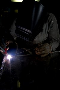 US Navy 080809-N-7730P-060 Hull Maintenance Technician (HT) 3rd class Joe Vanhorn brazes a shelf to go in a supply storeroom aboard the Nimitz-class aircraft carrier USS Ronald Reagan (CVN 76) photo