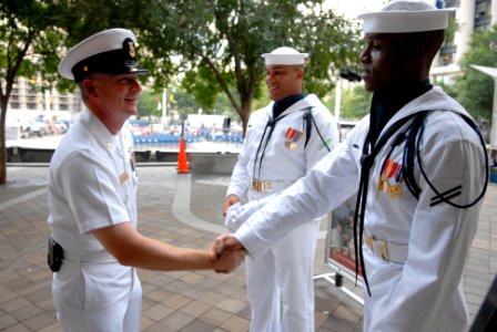 US Navy 080812-N-9818V-081 Fleet Master Chief Rick West, U.S. Fleet Forces Command, left, meets Airman Apprentice Mervin Laravasquez, center, and Culinary Specialist Seaman Apprentice Drayvon Hughes, both assigned to the U.S. N