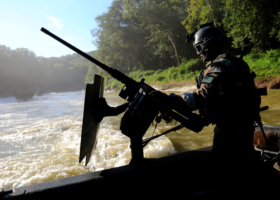 US Navy 080811-N-4205W-014 A Special Warfare Combatant-craft Crewman assigned to Special Boat Team 22 (SBT-22) mans an M240N .762mm machine gun