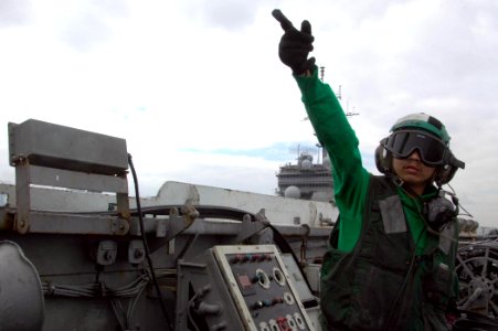 US Navy 080806-N-9170G-056 Aviation Boatwain's Mate (Equipment) 3rd Class Michael Ogalino, from Orlando, Fla., launches an F-A-18C Hornet assigned to Strike Fighter Squadron (VFA) 192 from the aircraft carrier USS Kitty Hawk (C