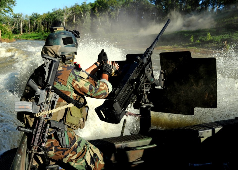 US Navy 080811-N-4205W-011 A Special Warfare Combatant-craft Crewman assigned to Special Boat Team 22 (SBT-22) reloads an M2HB .50 caliber machine gun