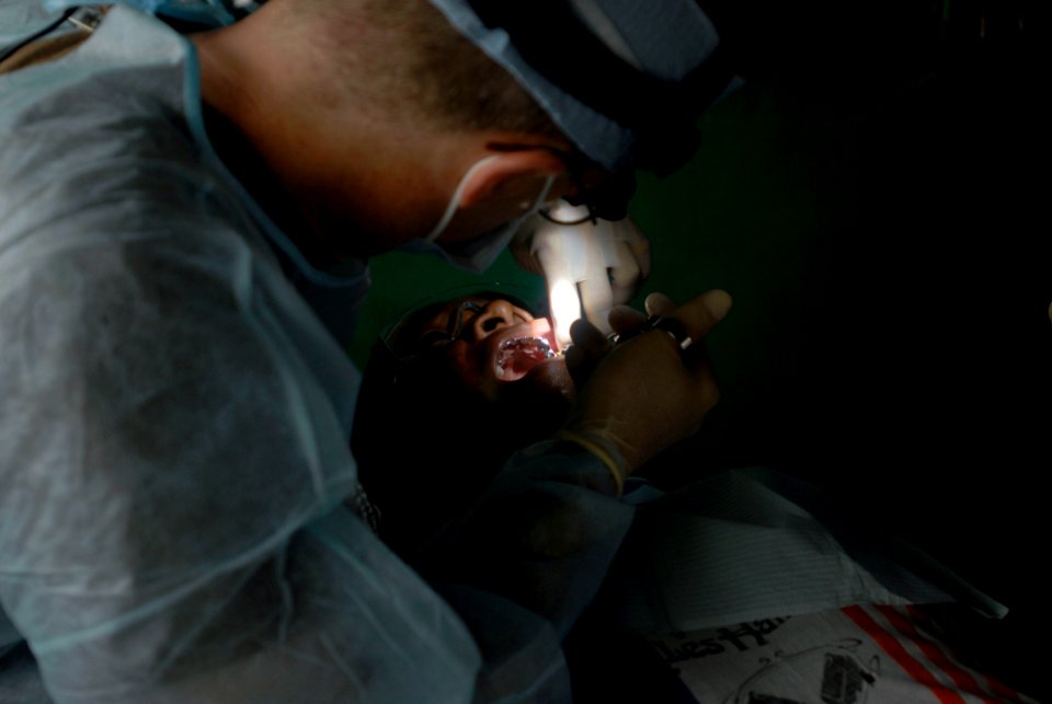 US Navy 080813-N-3595W-144 A dental volunteer embarked aboard the amphibious assault ship USS Kearsarge (LHD 3) gives a dental exam to a Nicaraguan citizen during a Continuing Promise 2008 humanitarian assistance project