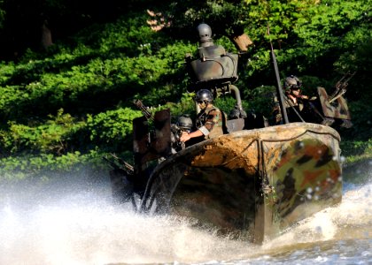 US Navy 080811-N-4205W-031 Special Warfare Combatant-craft Crewmen assigned to Special Boat Team 22 (SBT-22) conduct live-fire immediate action drills photo
