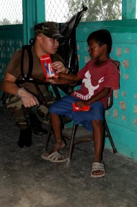 US Navy 080813-N-7955L-001 Hospital Corpsman 2nd Class Soutsakhone Sanethavong teaches a child how to use a toothbrush during a Continuing Promise 2008 medical humanitarian assistance project in Taupi, Nicaragua photo