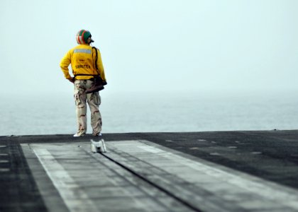 US Navy 080811-N-7981E-441 Lt. Cmdr. Gordon Lewis, from Atlanta, Ga., looks out over the North Arabian Sea as he prepares to launch his boots from the No. 2 Catapult of the aircraft carrier USS Abraham Lincoln (CVN 72)
