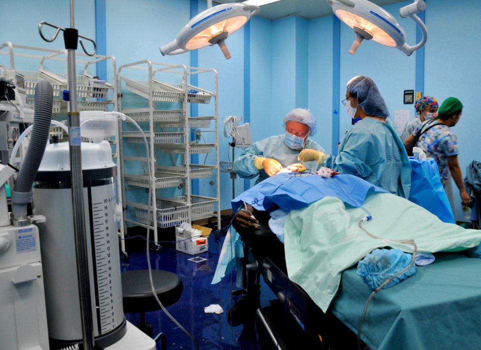 US Navy 080811-N-9689V-004 Operation Smile volunteers Dr. Robert Russell, a plastic surgeon from Springfield, Ill., and his assistant Maria Velasquez, perform reconstructive surgery on 21-year-old Solomon Maitava