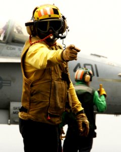 US Navy 080811-N-9898L-260 n aviation boatswain's mate (Handling) directs traffic on the flight deck of the aircraft carrier USS Abraham Lincoln (CVN 72)