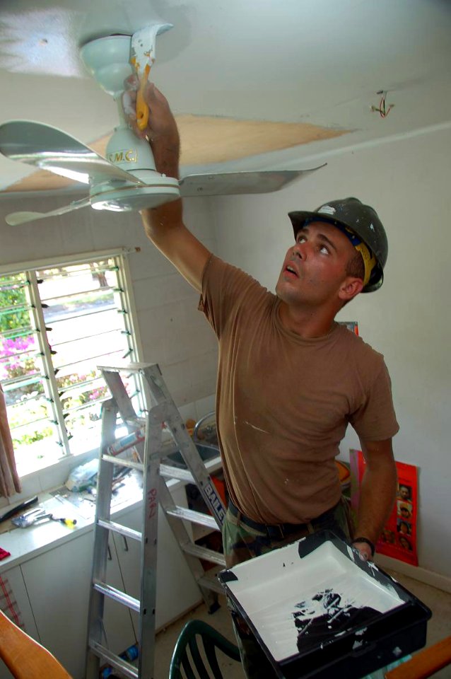 US Navy 080810-N-7498L-225 Builder Constructionman Thomas Russell, from Malta, Ohio, assigned to Naval Mobile Construction Battalion (NMCB) 133, paints the ceiling of the University of Papua New Guinea clinic building