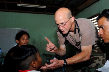US Navy 080812-N-9774H-128 Lt. Cmdr. Louis Cimoreli onducts a neurological exam on a patient at Juan Comenius High School during a humanitarian assistance project photo