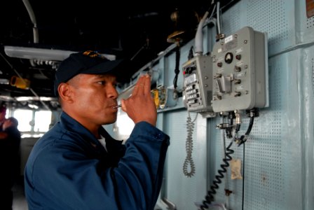 US Navy 080813-N-1635S-001 Boatswain's Mate 2nd Class Samson Kattil, from Hawaii, pipes the ship's whistle from the pilothouse of the Arleigh Burke-class guided-missile destroyer USS Howard (DDG 83) photo