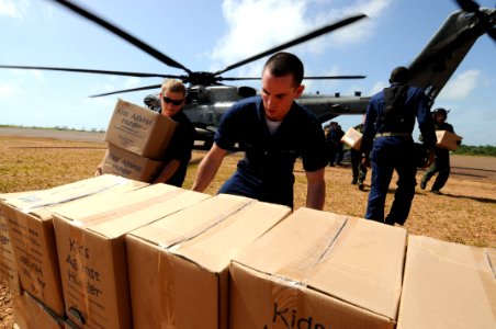 US Navy 080814-N-8907D-046 Operations Specialist Seaman Apprentice Richard Vickers and Electronics Technician 2nd Joshua Seabourn, both embarked aboard the amphibious assault ship USS Kearsarge (LHD 3), unload boxes of food don photo