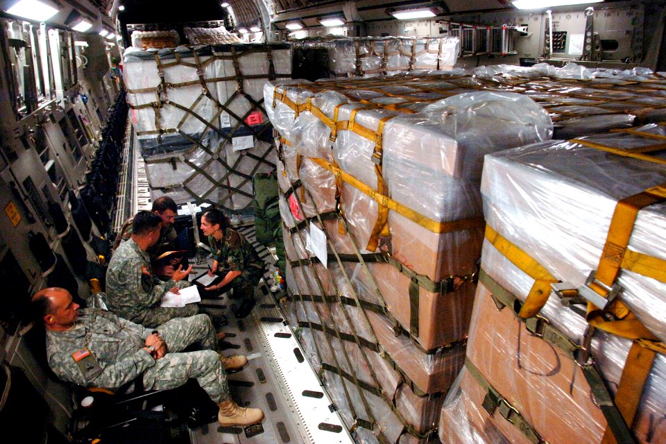 US Navy 080813-F-1014W-175 While en route to Tbilisi, Georgia, from Ramstein Air Base, Germany, a small group of U.S. Army, Navy and Air Force officers discuss details of the joint humanitarian assistance delivery